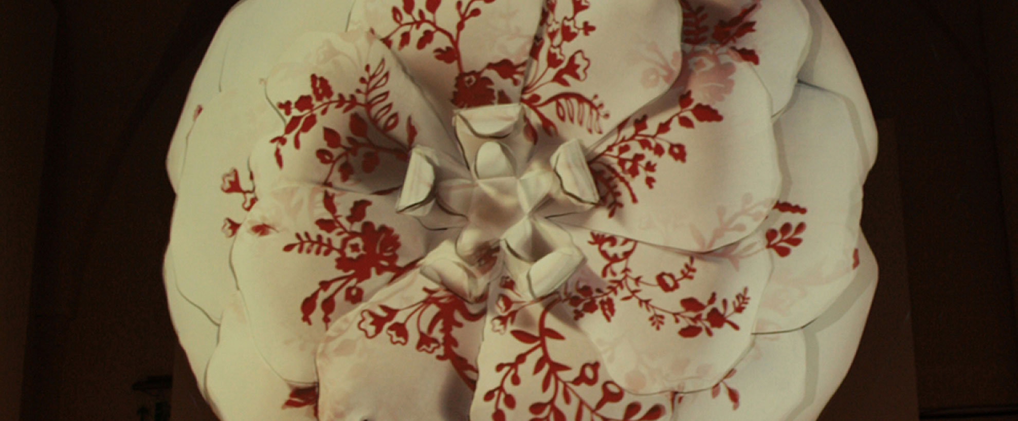 A white rose with red floral pattern on the petals