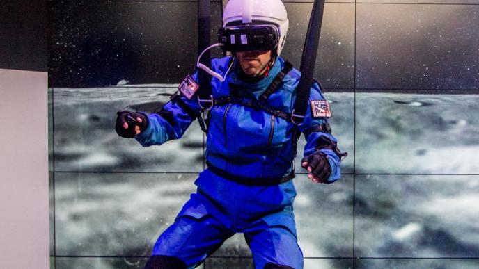 user suspended in air with braces wearing a safety suit and helmet with the moon surface and earth in space in the background