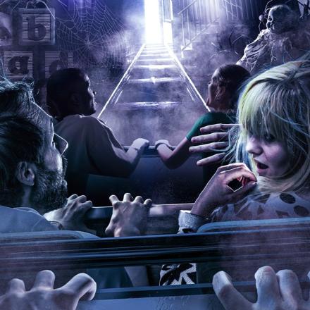 An illustration of people on a roller coaster ride who look scared. The rollercoaster is driving into a haunted mansion.