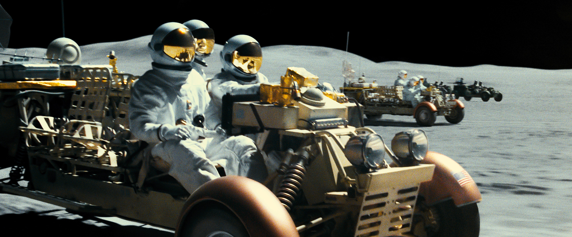 Astronauts driving space-age vehicles on the moon