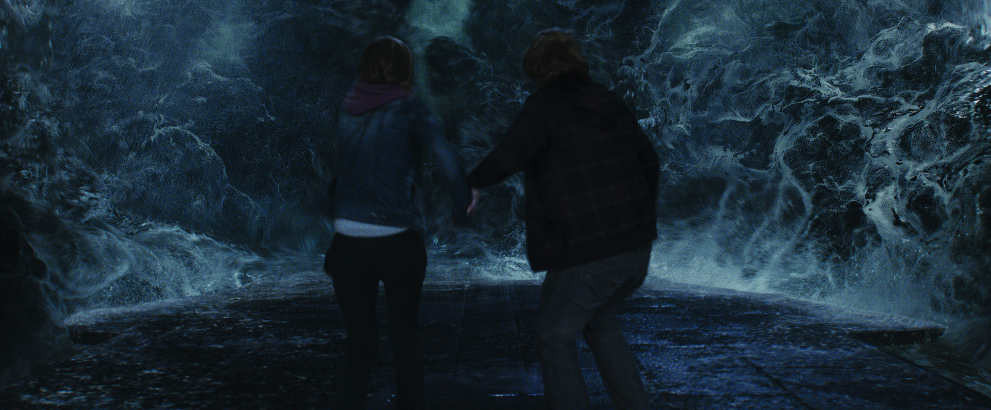 Ron and Hermione back away from a giant wave