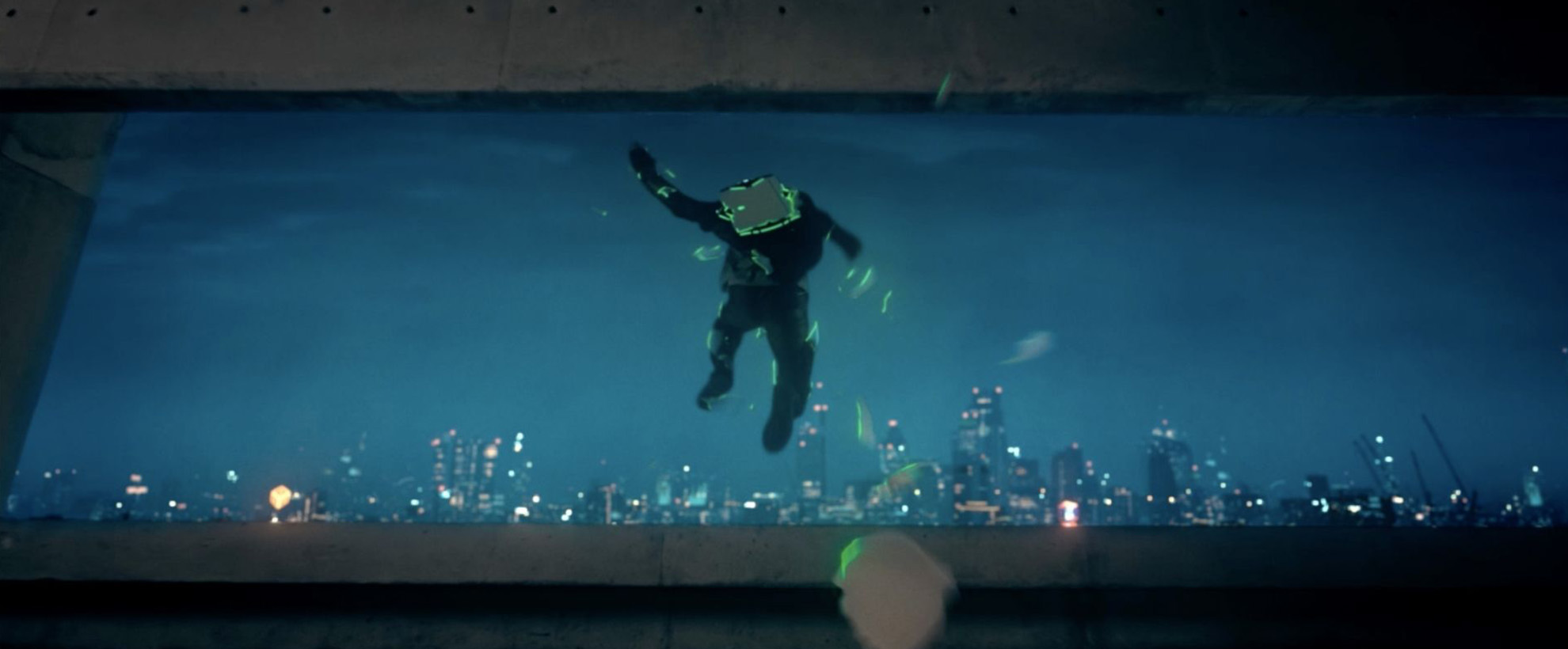 A person jumps off a building with a glowing green backpack on with a city skyline in the background