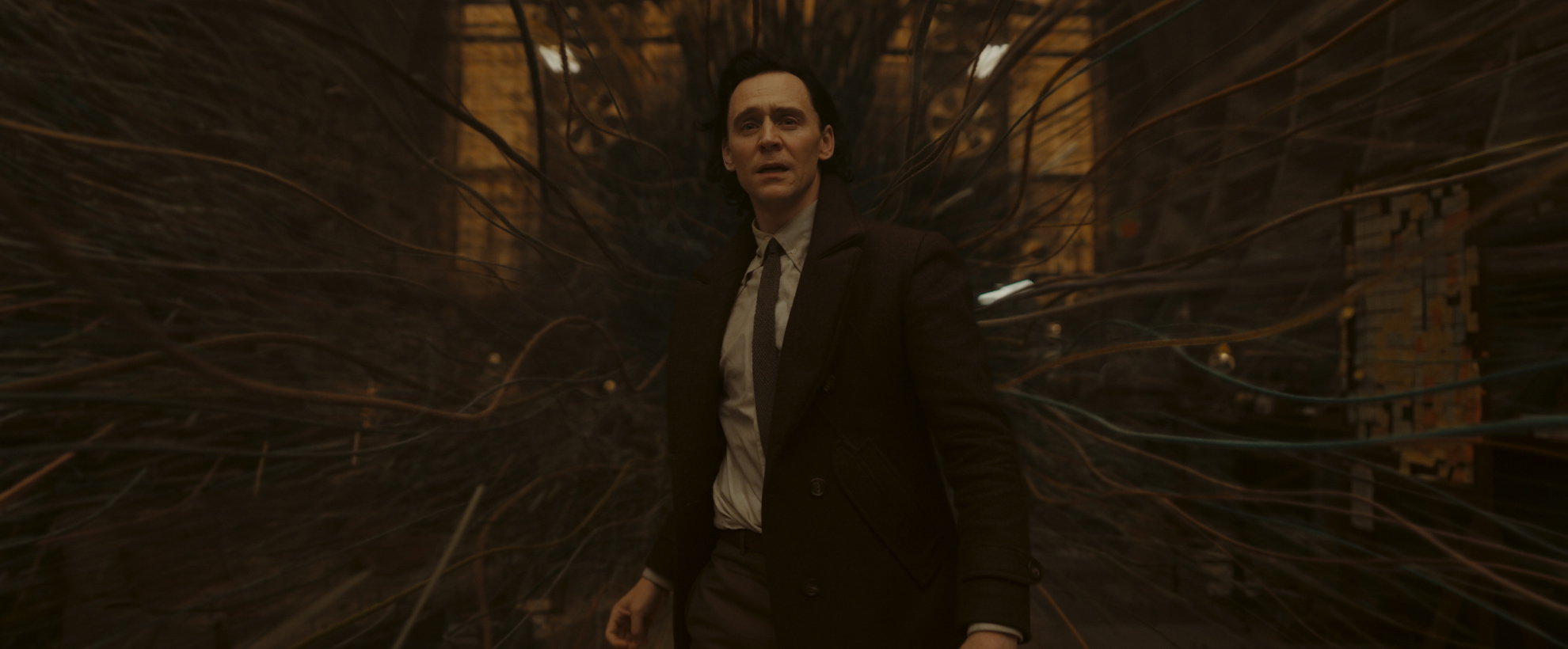 Loki stands in a room as it spaghettifies around him