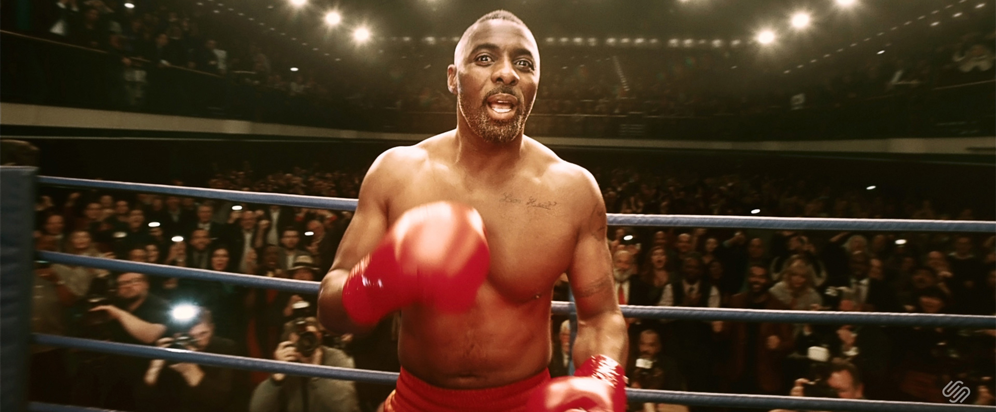 Idris Elba wearing boxing gloves 