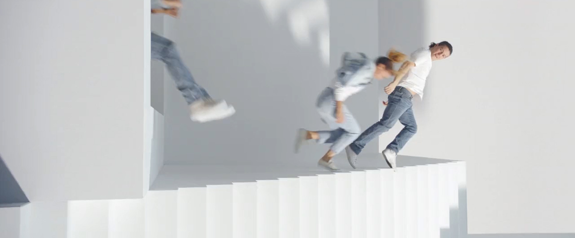 A woman and a child are jumping off a set of stairs that a laying their side.