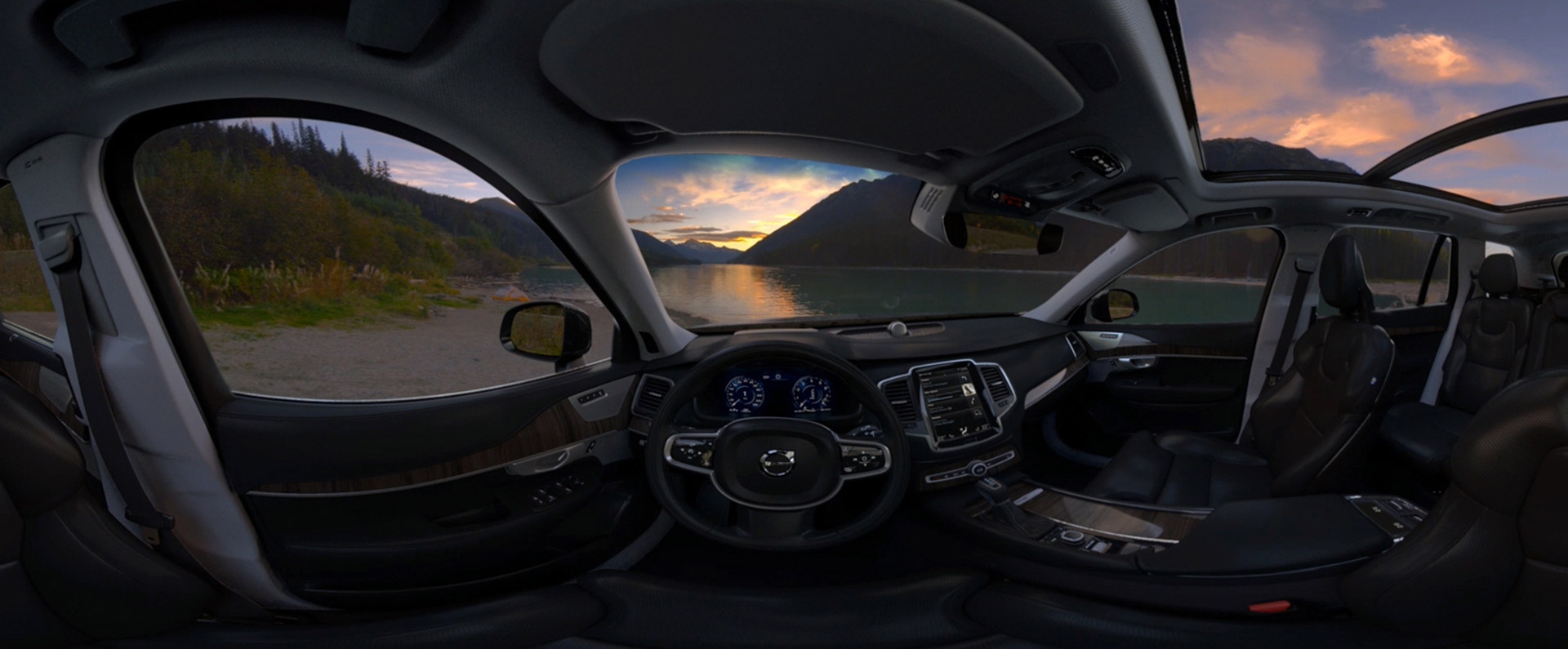 The interior of a Volvo car showing a beautiful landscape outside the windows.
