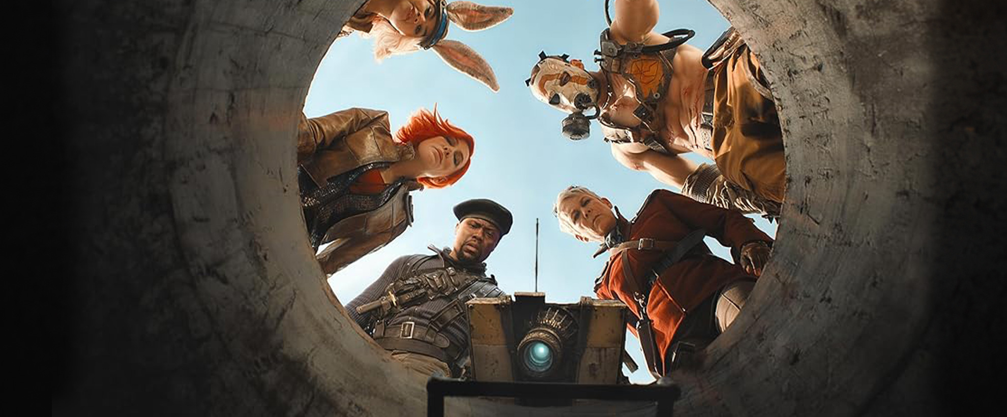 The cast of Borderlands peering down a manhole or drain