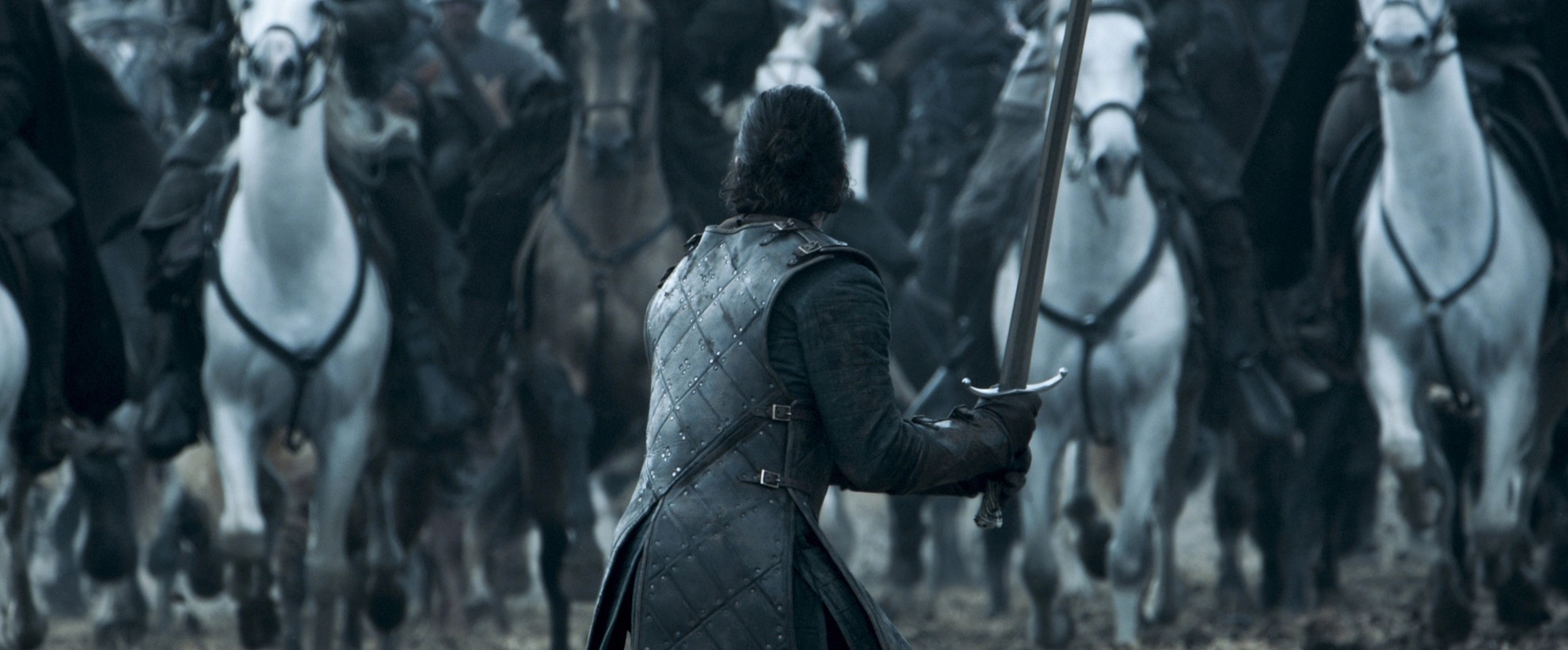 Game of Thrones - a man holds a sword, facing an army on horseback