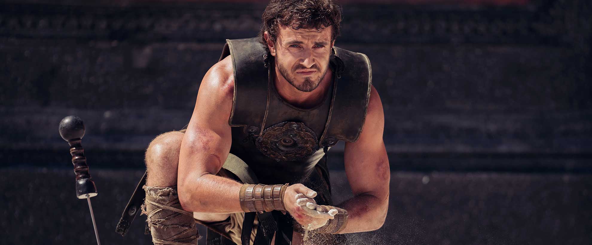 Paul Mescal in Gladiator 2, kneeling in a coliseum. 