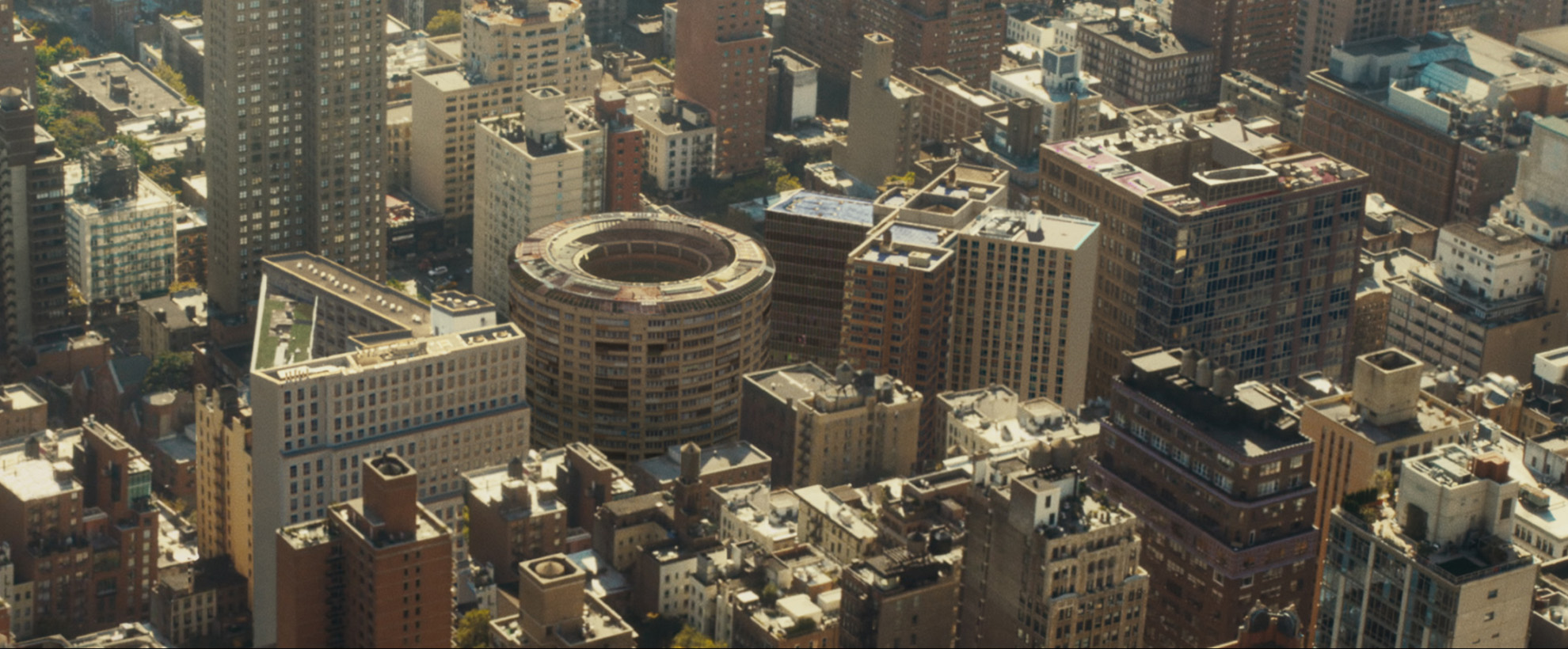 A birds eye view of a city block with some of the buildings in the shape of Playstation controller symbols. 