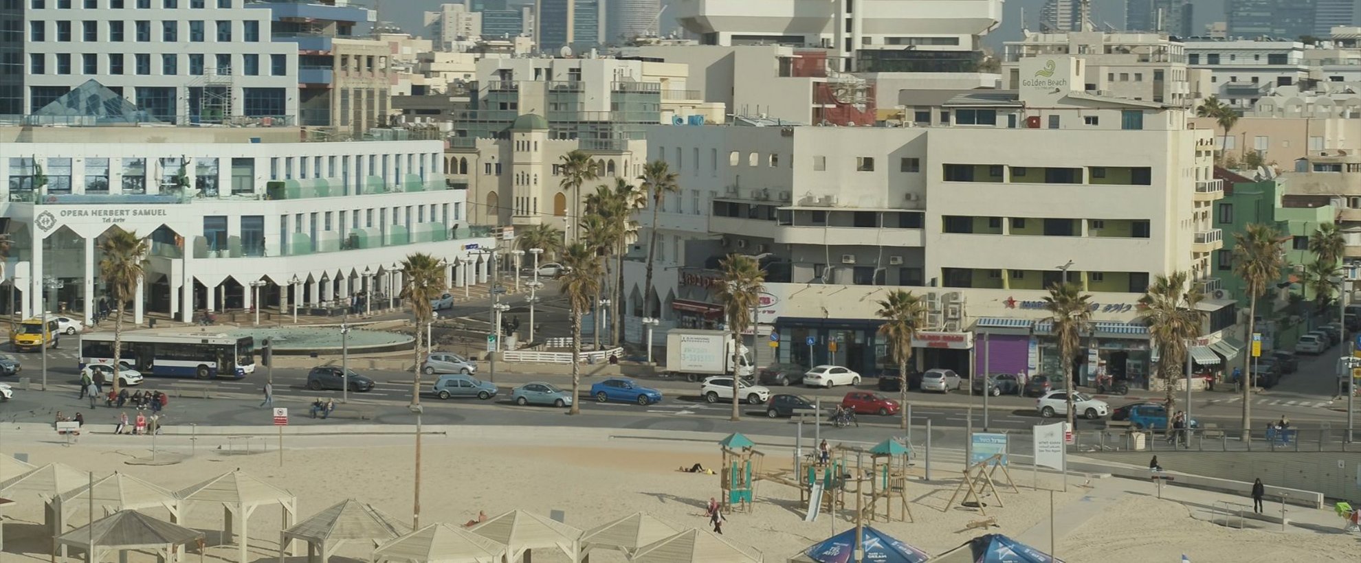 A view from the beach towards a city, dated in the 1960s