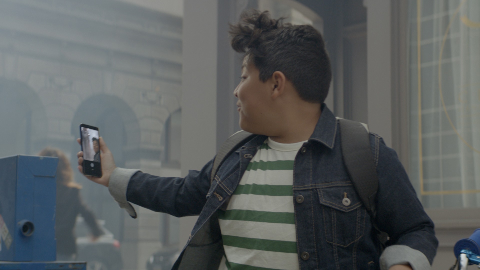 side view of a man holding up and looking into a google pixel 3 phone