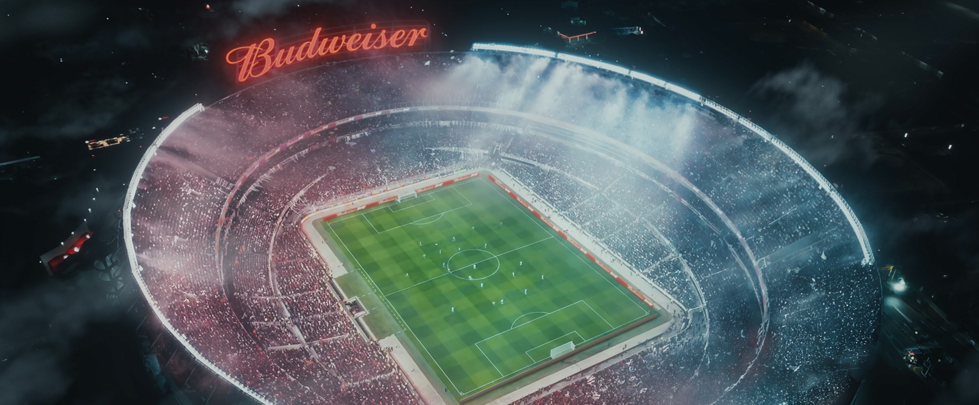 A soccer/football stadium with a large CG Budweiser sign. The stadium is packed with a large crowd (which has been made by VFX Crowd Simulation) 