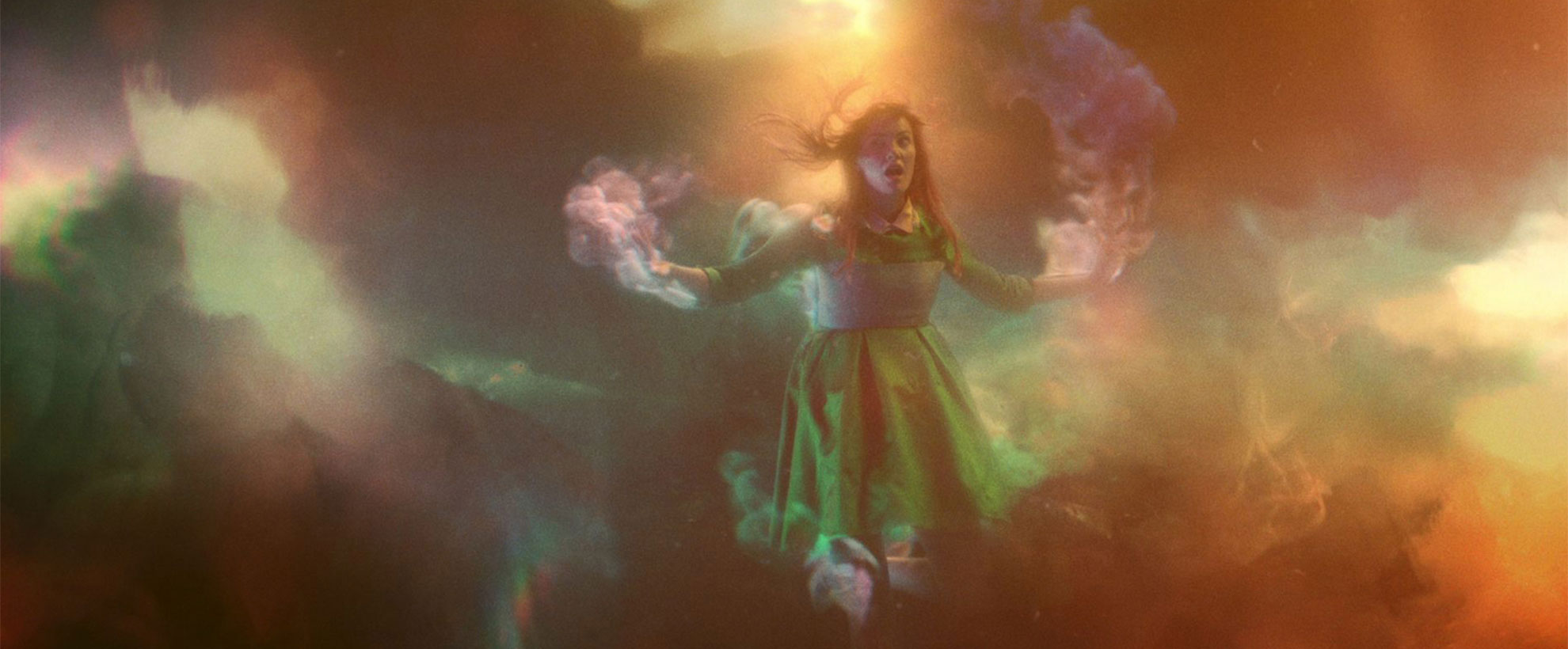 A woman surrounded in colourful CGI smoke, an effect simulated by Framestore