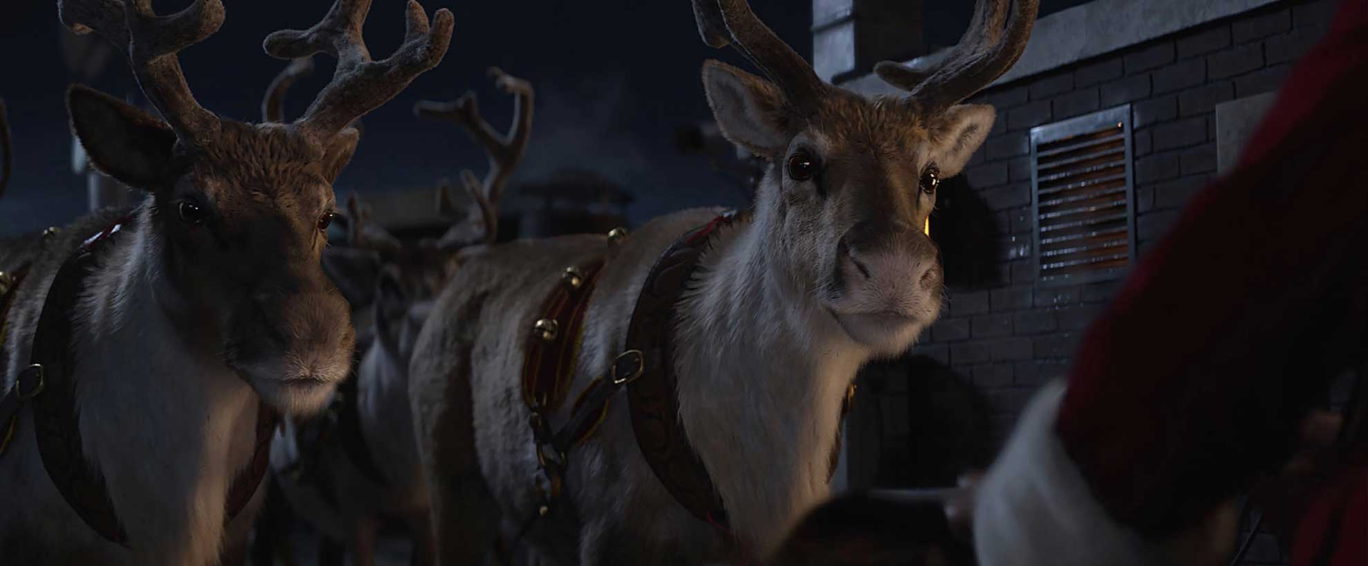 Two CGI animated reindeer in the snowy nighttime