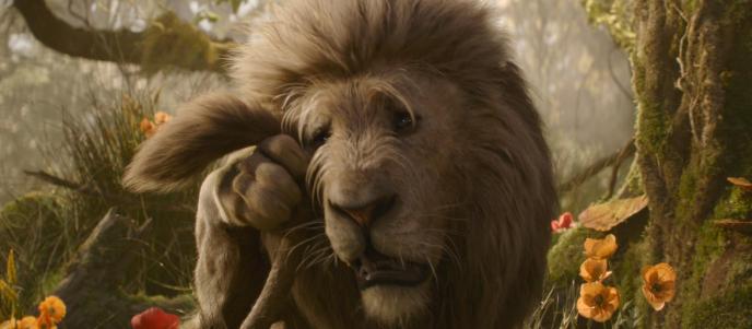 The Cowardly Lion from Wicked: For Good dries tears with his tail. The Lion is CGI Animation, voiced by Colman Domingo.