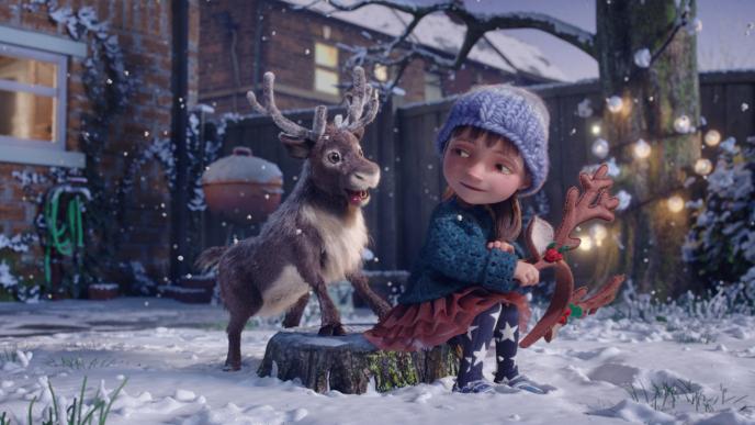 an animated child playing with a reindeer while holding an antler headpiece