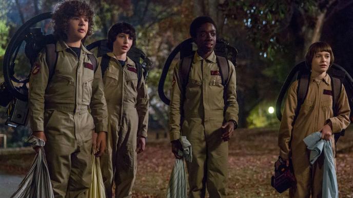 stranger things characters dustin, mike, lucas and will cosplaying as the ghostbusters