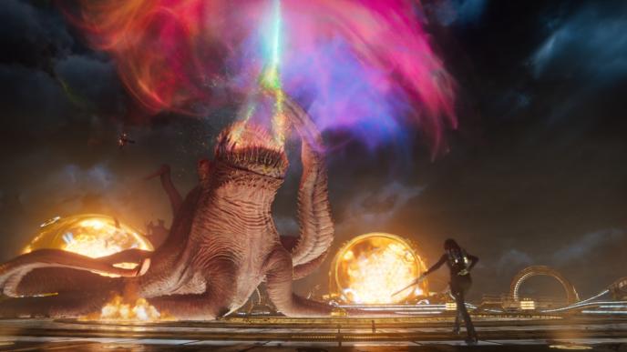 abilisk monster looking up with its mouth open. there is colourful mist coming out of it mouth. gamore is walking towards it with a sword in her hand and star-lord is holding a bazuka while hovering next to it with a jet pack