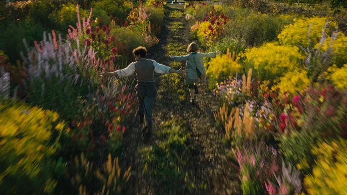 two children running through the secret garden