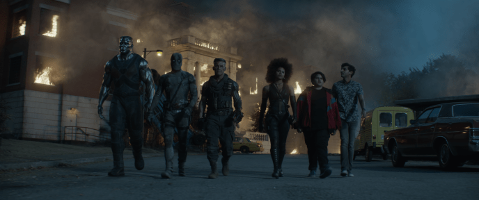 characters from deadpool 2 walking together in front of an explosion