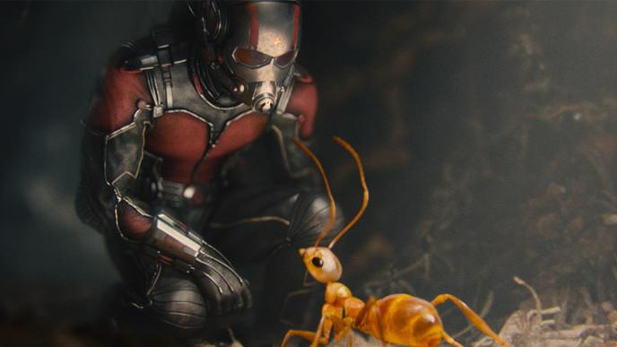 a minuscule ant man crouching down and talking to an ant