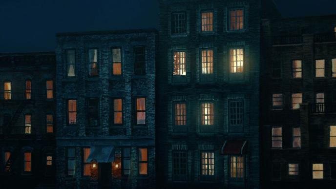 outside perspective of an apartment complex lit up in nighttime