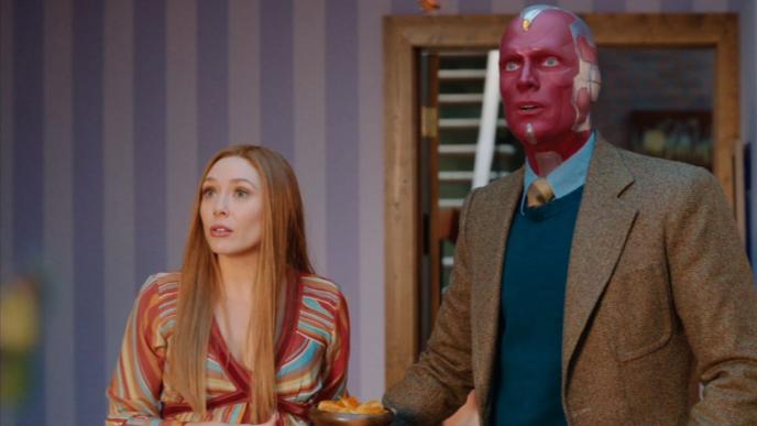 elizabeth olsen as wanda maximoff and paul bettany as vision standing side by side looking ahead to the left