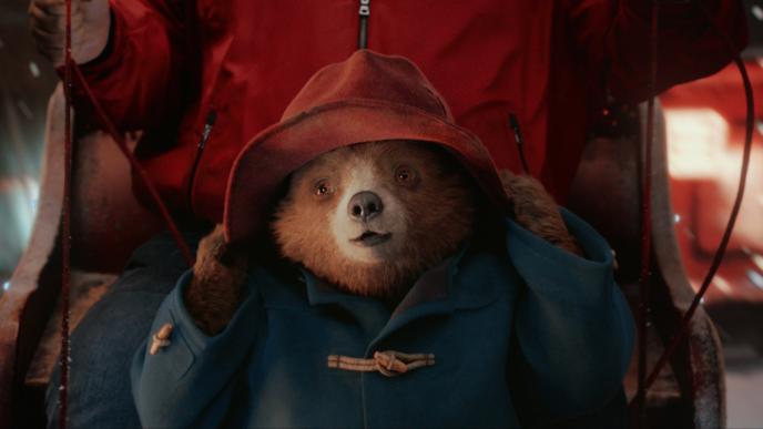 cg animated paddington bear holding onto its hat