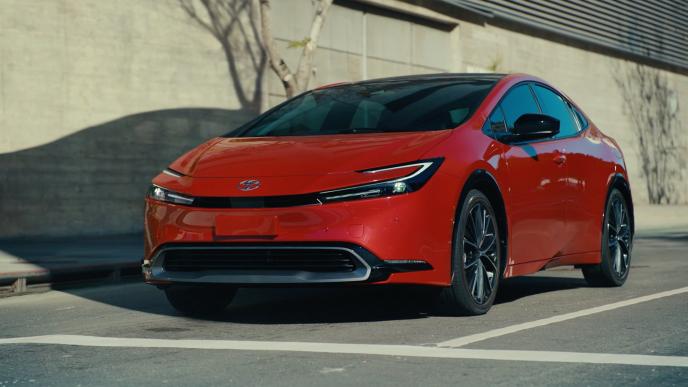 a red 2023 Toyota Prius at a stoplight