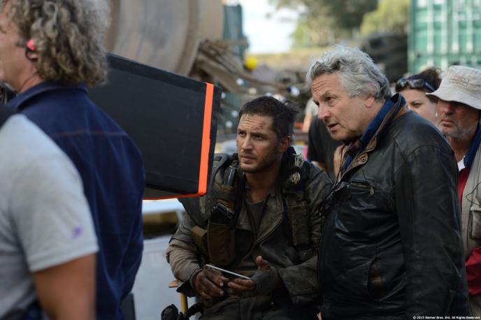 Tom Hardy and George Miller watch a monitor behind the scenes of Mad Max: Fury Road