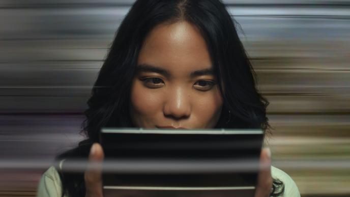 A woman games on her Samsung Galaxy Z Fold6