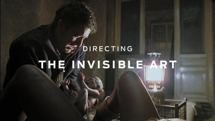 A man holding a CGI photorealistic baby with text saying "Directing the Invisible Art" over the top in white. 