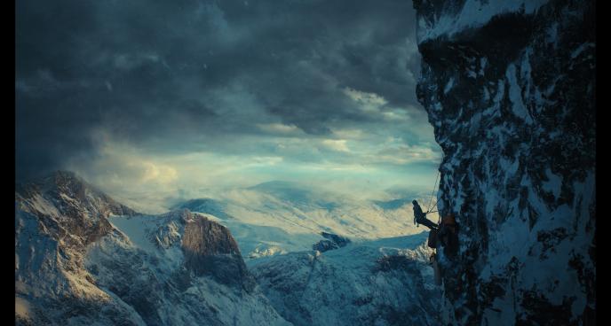 A wide shot of a climber ascending Norway's Troll Wall
