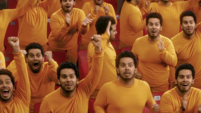 a person in a yellow long-sleeve duplicated fourteen times, cheering on