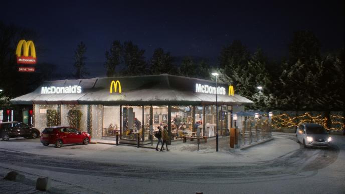 a mcdonald's building decorated with christmas lights