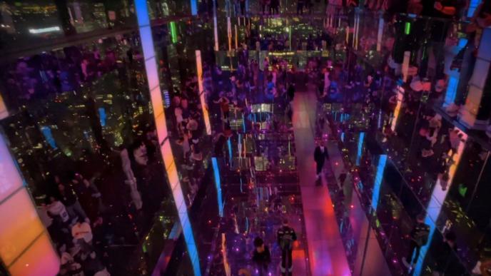 interior of a busy bar that is lit up with mood lights