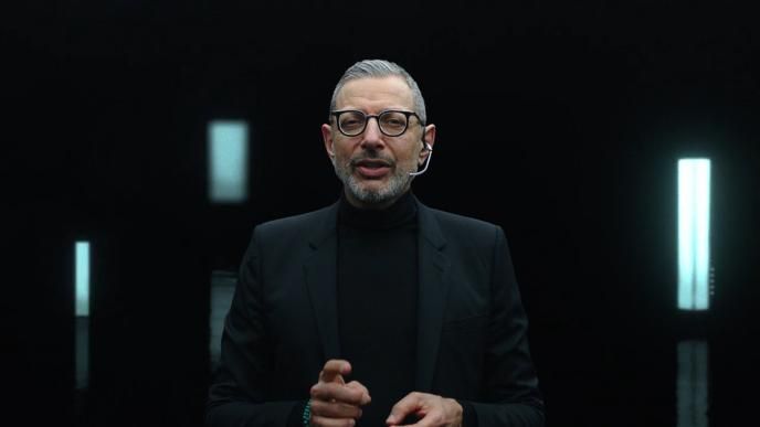 front view of actor jeff goldblum wearing a suit with a headset microphone