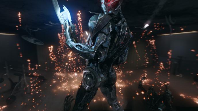 sub-ultron robot with a lit up blade arm looking into the camera with sparks surrounding it
