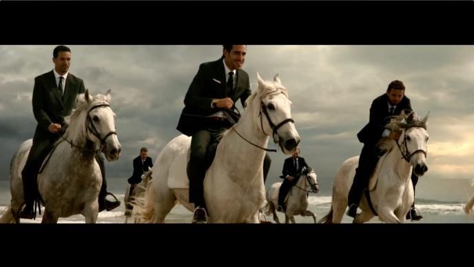 businessmen riding white horses by the sea