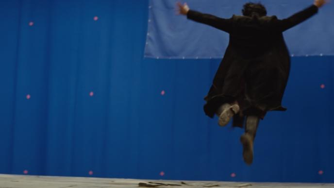 actor jumping in front of a blue screen