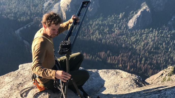 cameraman setting up 360 view camera on top of the el capitan cliff in yosemite national park