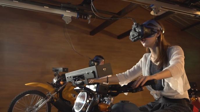 side view of a woman wearing a vr headset that is connected to a motorbike