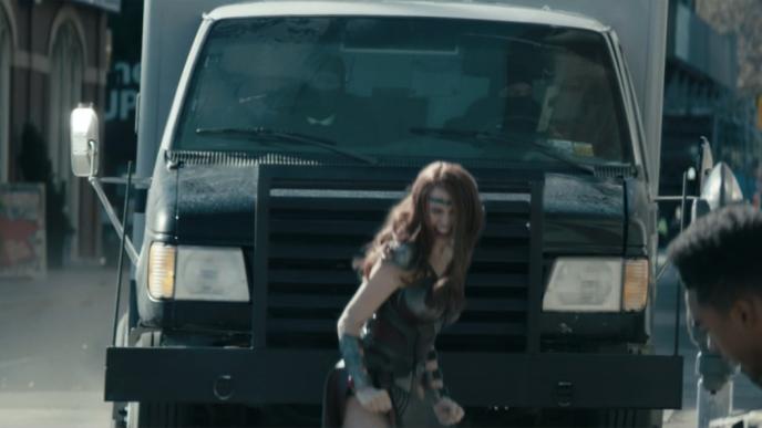 actress dominique mcelligott as character maggie shaw shouting in front of a truck 
