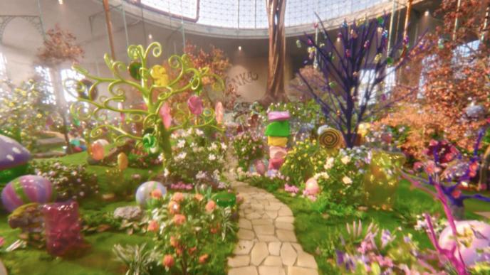 A fantastical room filled with creations from Willy Wonkas Chocolate Factory including trees and plants with sweets hanging from them and a chocolate tree.
