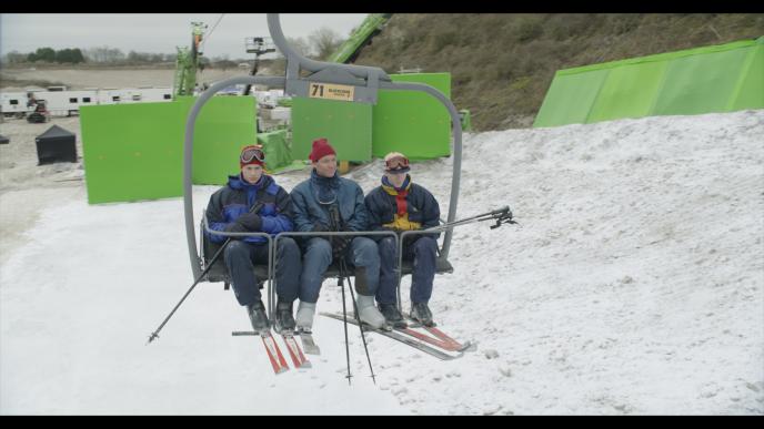 Actors playing young King Charles, Prince William and Harry riding a ski lift, behind the scenes 