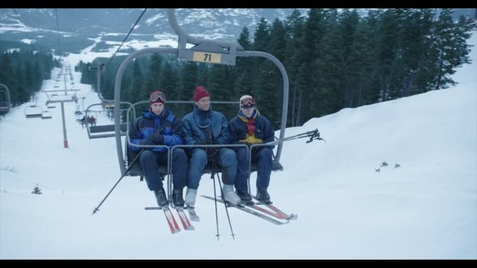 Actors playing young King Charles, Prince William and Harry riding a ski lift, final shot