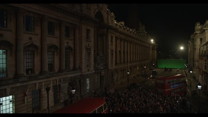 Wide shot of the exterior of the ritz hotel, with a green screen in the distance. Behind the scenes.