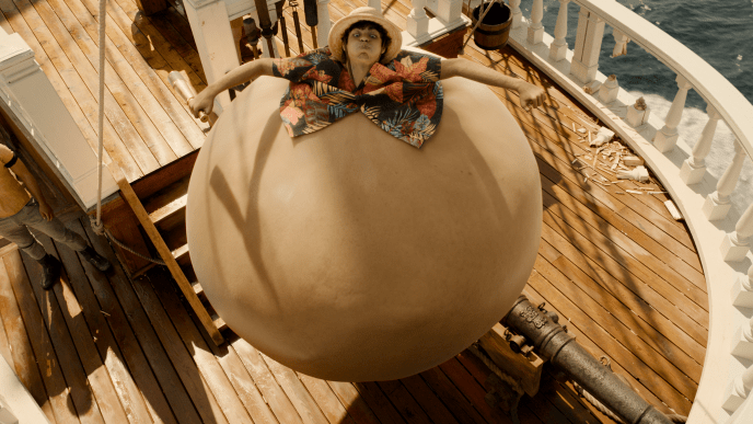 Luffy from One Piece on a boat swelled up like a giant balloon