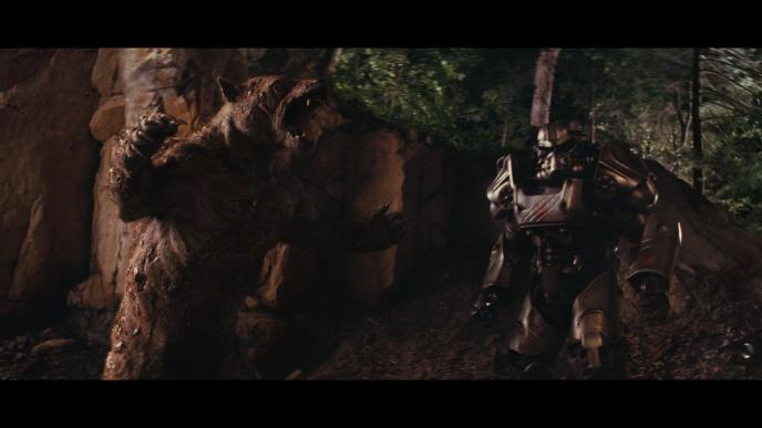Mutated bear, otherwise known as the Yao Gui looking at a robot with a rocky background behind  